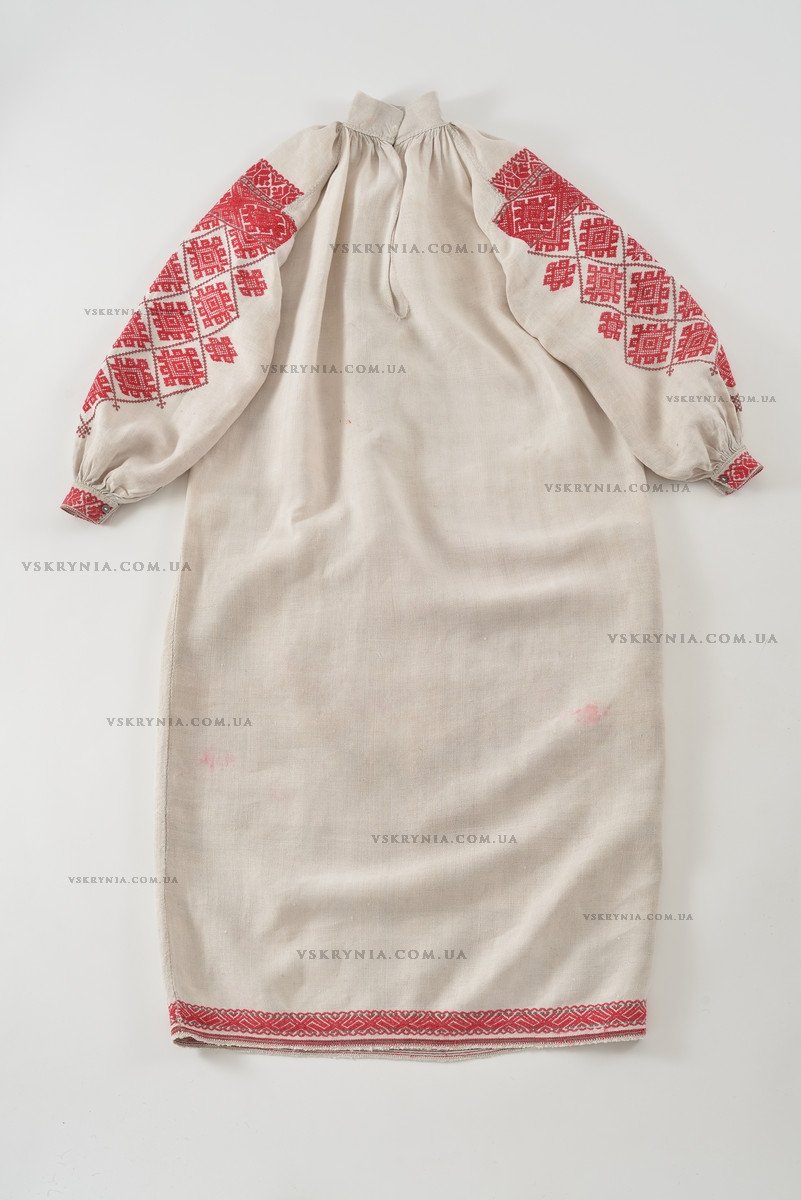 Women's linen shirt with rows of red embroidered rhombuses on both sleeves and along the hem
